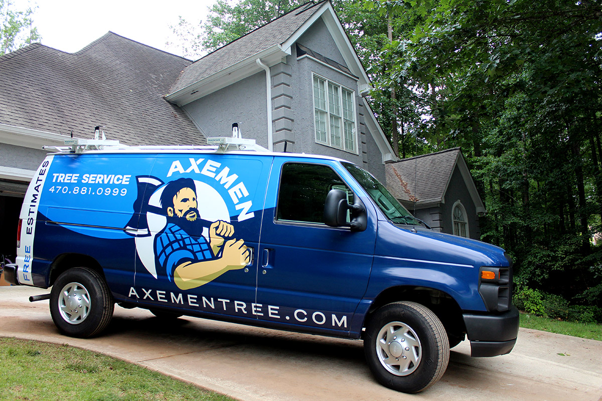 Axemen Tree Service van parked in front of a home for a tree assessment